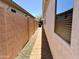 Paver side yard walkway between the home and block wall, with desert landscaping at 18430 E Azul Ct, Gold Canyon, AZ 85118