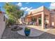 Outdoor space with a fountain, patio seating, grill, and low-maintenance landscaping at 20148 N Big Dipper Dr, Maricopa, AZ 85138