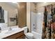 Bathroom featuring a vanity sink and toilet next to a tub with a patterned curtain at 20148 N Big Dipper Dr, Maricopa, AZ 85138