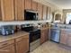 Well-lit kitchen featuring wooden cabinets, stainless steel appliances, and a spacious countertop area for food preparation at 20148 N Big Dipper Dr, Maricopa, AZ 85138