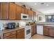 Bright kitchen with upper cabinets, essential appliances, and a view into the living room at 20148 N Big Dipper Dr, Maricopa, AZ 85138