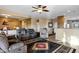 Spacious living room featuring a ceiling fan, neutral paint, tile floors, and comfortable seating at 20148 N Big Dipper Dr, Maricopa, AZ 85138