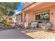 Charming covered patio with comfortable seating on brick pavers, perfect for outdoor living at 20148 N Big Dipper Dr, Maricopa, AZ 85138