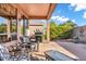 Relaxing outdoor patio with comfortable seating, grill, and paved brick flooring at 20148 N Big Dipper Dr, Maricopa, AZ 85138