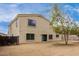 Back of a house featuring a door and multiple windows overlooking a vast, undeveloped backyard at 2023 S 106Th Ave, Tolleson, AZ 85353