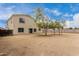 View of the back of the house and a spacious, blank slate backyard ready for customization at 2023 S 106Th Ave, Tolleson, AZ 85353