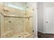 Luxurious bathroom shower featuring tasteful tile work, glass enclosure, and convenient built-in shelving at 2023 S 106Th Ave, Tolleson, AZ 85353