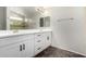 Bathroom vanity with dual sinks, a large mirror, and black hardware at 2023 S 106Th Ave, Tolleson, AZ 85353