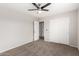 Inviting bedroom with neutral tones, ceiling fan, plush carpet, and closet, offering a serene ambiance at 2023 S 106Th Ave, Tolleson, AZ 85353