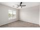 Bright bedroom features neutral carpet and ceiling fan, creating a relaxing and inviting space at 2023 S 106Th Ave, Tolleson, AZ 85353