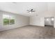 Main bedroom with carpet, fan, and natural light from a large window at 2023 S 106Th Ave, Tolleson, AZ 85353