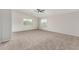 Large main bedroom with carpet, fan, and natural light from big windows at 2023 S 106Th Ave, Tolleson, AZ 85353