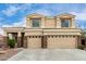 Two-story home featuring a three-car garage and desert landscaping at 2023 S 106Th Ave, Tolleson, AZ 85353