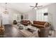 Inviting living room with brown leather sofas, neutral tones, and tile flooring for a cozy and sophisticated ambiance at 2023 S 106Th Ave, Tolleson, AZ 85353