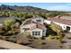 Aerial view of a home featuring solar panels, desert landscaping, and mountain views at 20701 W Minnezona Ave, Buckeye, AZ 85396