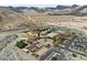 Wide aerial shot of the community clubhouse, parking, pools and surrounding mountain landscape at 20701 W Minnezona Ave, Buckeye, AZ 85396