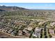 Aerial view of community showcases many homes with tile roofs and desert landscaping at 20701 W Minnezona Ave, Buckeye, AZ 85396