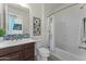 Bathroom features a tiled shower over tub and a single sink with decorative backsplash at 20701 W Minnezona Ave, Buckeye, AZ 85396