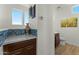 Neutral-toned powder room with marble countertop and backsplash, next to private toilet at 20701 W Minnezona Ave, Buckeye, AZ 85396