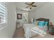 Cozy bedroom with neutral carpet, ceiling fan, and windows with plantation shutters at 20701 W Minnezona Ave, Buckeye, AZ 85396