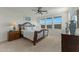 Bright bedroom features a ceiling fan and three windows that provide natural light at 20701 W Minnezona Ave, Buckeye, AZ 85396