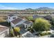 A Spanish-style home with a red tile roof is surrounded by desert landscaping and mountains in the distance at 20701 W Minnezona Ave, Buckeye, AZ 85396