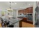 Well-lit kitchen features granite counters, stainless steel appliances, and tile backsplash at 20701 W Minnezona Ave, Buckeye, AZ 85396