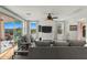 Bright living room featuring hardwood floors, large windows, and a ceiling fan at 20701 W Minnezona Ave, Buckeye, AZ 85396