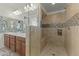 Tiled shower with built-in bench and niche; double sink vanity with decorative tile backsplash at 20701 W Minnezona Ave, Buckeye, AZ 85396