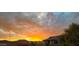 A vivid sunset over a home, creating a picturesque desert scene with a colorful sky at 20701 W Minnezona Ave, Buckeye, AZ 85396