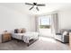 Comfortable bedroom featuring neutral carpet, a ceiling fan, and natural light from the window at 21295 E Estrella Rd, Queen Creek, AZ 85142