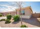 Side view of home showing well-maintained landscaping with green bushes and desert rock at 21295 E Estrella Rd, Queen Creek, AZ 85142