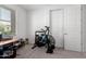 Home gym space featuring carpet flooring, white walls, and Rogue Echo Bike at 21295 E Estrella Rd, Queen Creek, AZ 85142