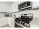 Modern kitchen features stainless steel appliances, gas cooktop, and white quartz countertops at 21295 E Estrella Rd, Queen Creek, AZ 85142