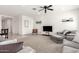 Bright living room with neutral carpet, ceiling fan, stylish sofas, and access to other rooms at 21295 E Estrella Rd, Queen Creek, AZ 85142