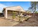 Large backyard featuring gravel landscaping, a covered patio area, and desert foliage at 2340 S 238Th Ln, Buckeye, AZ 85326