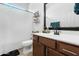 Bright bathroom with a bathtub-shower combo, modern vanity, and a decorative mirror and lighting at 2340 S 238Th Ln, Buckeye, AZ 85326