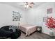 Cozy bedroom with wood-look flooring, ample lighting, and plenty of space for a bed and bean bag at 2340 S 238Th Ln, Buckeye, AZ 85326