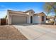 Charming single-story home featuring a tile roof, a two-car garage, and a well-manicured front yard at 2340 S 238Th Ln, Buckeye, AZ 85326