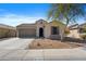 Charming single-story home featuring a well-manicured front yard and attached two-car garage at 2340 S 238Th Ln, Buckeye, AZ 85326