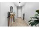 Inviting entryway featuring tile floors, neutral paint, arched doorways and a decorative console table at 2340 S 238Th Ln, Buckeye, AZ 85326