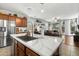 Kitchen featuring marble countertop island, stainless steel refrigerator, and view to the open living area at 2340 S 238Th Ln, Buckeye, AZ 85326