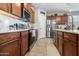 Bright kitchen features stainless steel appliances, dark wood cabinets, and a white subway tile backsplash at 2340 S 238Th Ln, Buckeye, AZ 85326