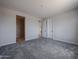 A bedroom with neutral walls and carpet, with en-suite entrance and walk-in closet at 2570 E Music Mountain Ave, Apache Junction, AZ 85119