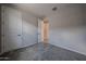 A light bedroom with neutral walls and carpet, featuring two doors, one en-suite and one closet at 2570 E Music Mountain Ave, Apache Junction, AZ 85119