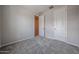 A bright bedroom with neutral walls and carpet, featuring an en-suite door and large closet at 2570 E Music Mountain Ave, Apache Junction, AZ 85119