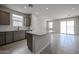 Spacious kitchen with gray cabinets, stainless steel appliances, and a central island overlooking the living area at 2570 E Music Mountain Ave, Apache Junction, AZ 85119
