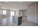 Kitchen island with gray cabinets and stone countertop, set within an open-concept layout with ample lighting at 2570 E Music Mountain Ave, Apache Junction, AZ 85119