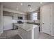 Bright kitchen featuring gray cabinets, stainless steel appliances, subway tile backsplash, and a spacious island at 2570 E Music Mountain Ave, Apache Junction, AZ 85119