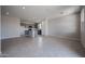 Bright, open living area with sightlines into the kitchen, featuring recessed lighting and neutral tile flooring at 2570 E Music Mountain Ave, Apache Junction, AZ 85119